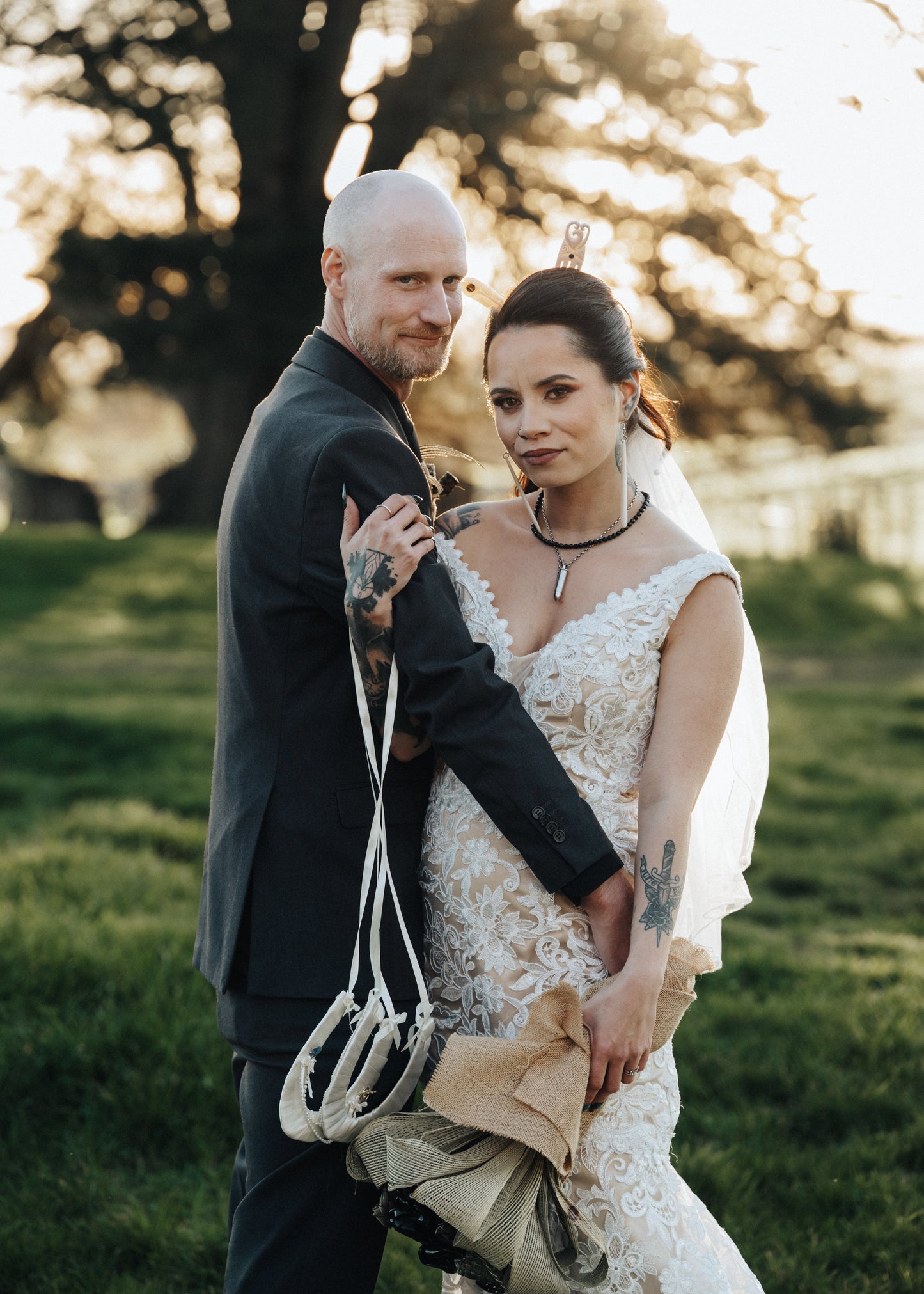Man and woman holding hands in a park with trees and grass in the background